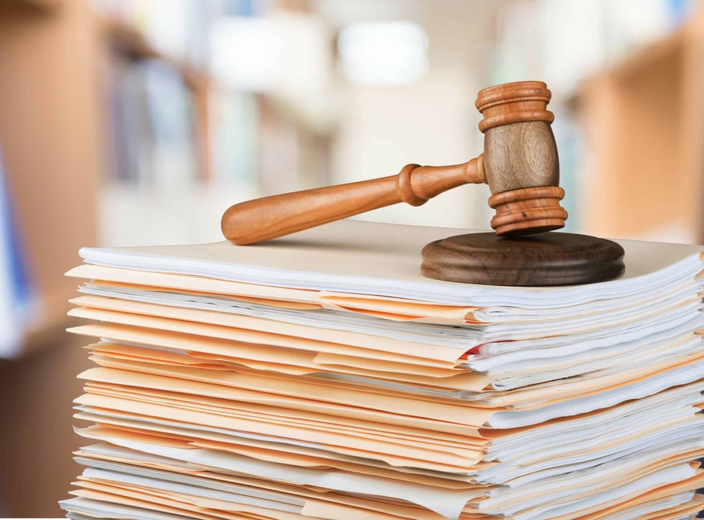Wooden gavel on a stack of legal documents representing EU supply chain sustainability legislation